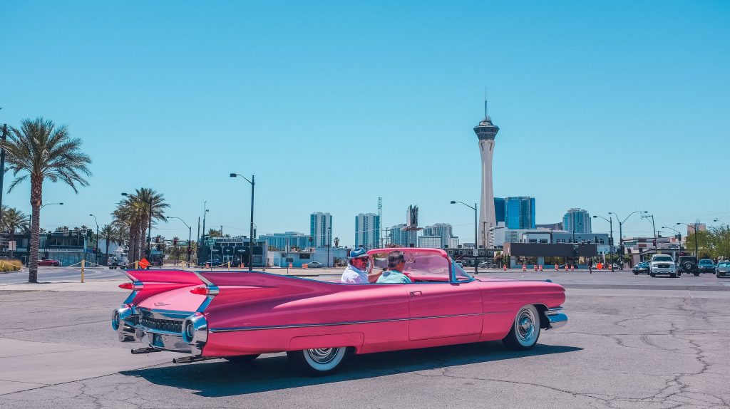 Guests enjoying a ride in a pink car at a Las Vegas event featuring a "360 Photo Booth in las vegas"